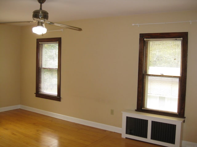 1071 River Blvd, Suffield, CT 06078 - unfurnished room with radiator heating unit, a ceiling fan, light wood-style floors, and baseboards