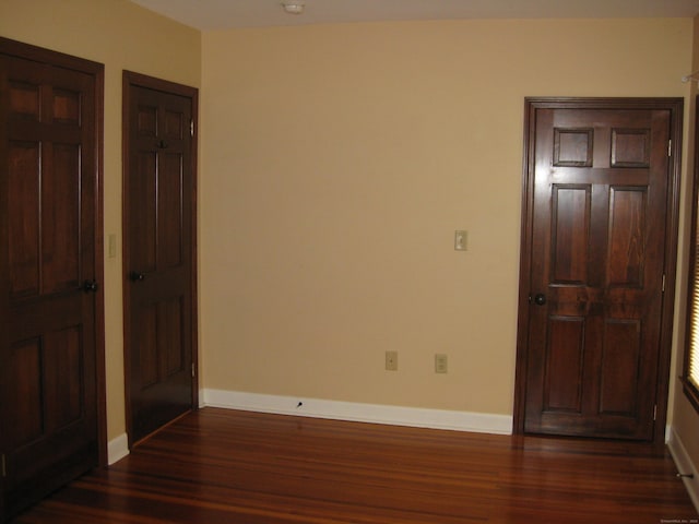 1071 River Blvd, Suffield, CT 06078 - unfurnished bedroom featuring dark wood-style floors and baseboards