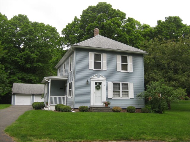 1071 River Blvd, Suffield, CT 06078 - view of front of house with a chimney, an outdoor structure, a front lawn, a garage, and a shingled roof