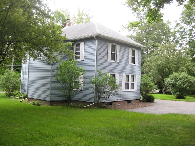 1071 River Blvd, Suffield, CT 06078 - view of property exterior featuring a chimney and a lawn