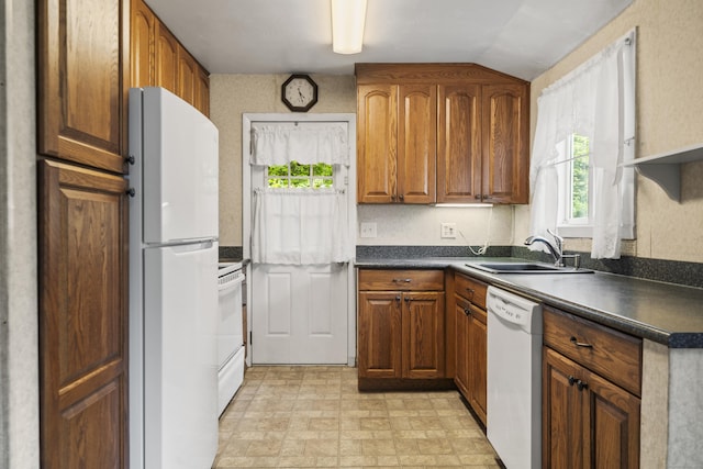 34 Benedict Dr, South Windsor, CT 06074 - kitchen featuring white appliances, dark countertops, and brown cabinetry