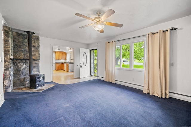 34 Benedict Dr, South Windsor, CT 06074 - unfurnished living room featuring a wood stove, a ceiling fan, a baseboard radiator, carpet floors, and a baseboard heating unit