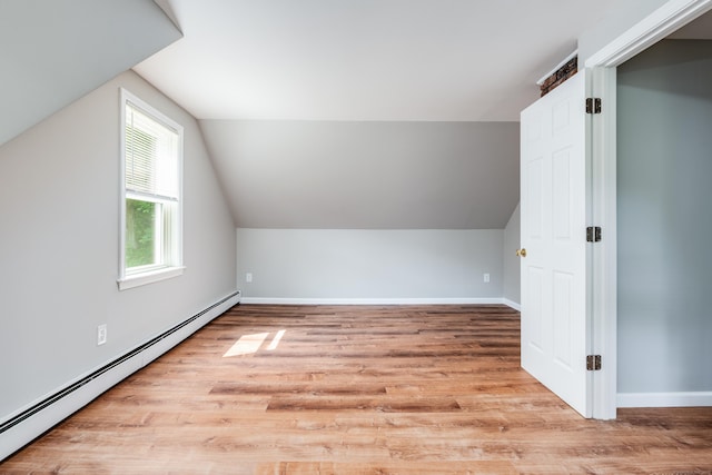 143 Clark Hill Rd, East Haddam, CT 06423 - additional living space with baseboard heating, lofted ceiling, light wood finished floors, and baseboards