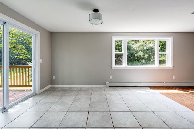 143 Clark Hill Rd, East Haddam, CT 06423 - spare room featuring a baseboard heating unit, plenty of natural light, baseboards, and light tile patterned floors