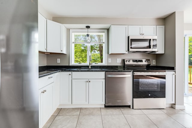 143 Clark Hill Rd, East Haddam, CT 06423 - kitchen with appliances with stainless steel finishes, a sink, white cabinets, dark stone countertops, and light tile patterned floors