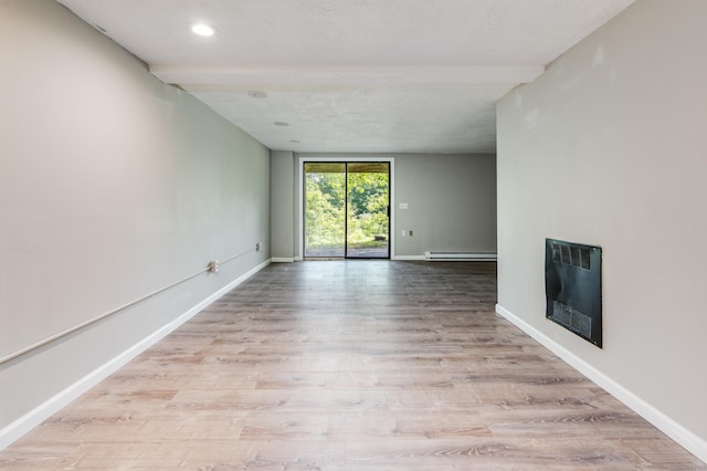 143 Clark Hill Rd, East Haddam, CT 06423 - unfurnished living room featuring a baseboard heating unit, heating unit, a fireplace, wood finished floors, and beam ceiling