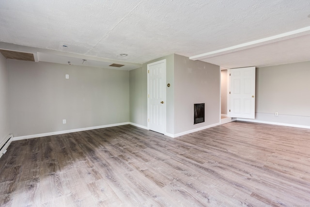 143 Clark Hill Rd, East Haddam, CT 06423 - unfurnished living room featuring a fireplace, wood finished floors, baseboards, and a textured ceiling
