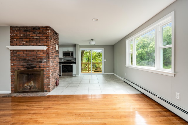 143 Clark Hill Rd, East Haddam, CT 06423 - unfurnished living room with a baseboard radiator, a fireplace, light tile patterned flooring, and baseboards