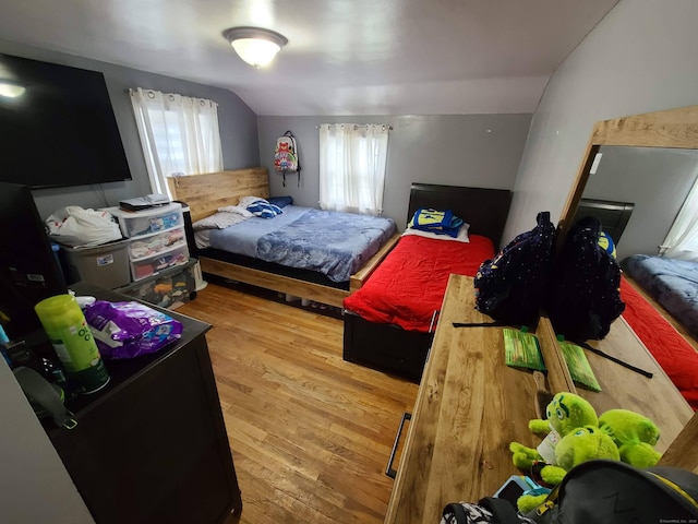 1437 Silver Ln, East Hartford, CT 06118 - bedroom with multiple windows, vaulted ceiling, and wood finished floors