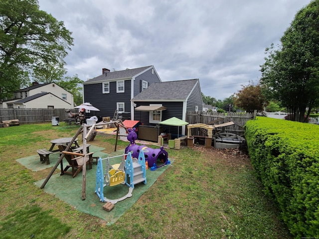 1437 Silver Ln, East Hartford, CT 06118 - rear view of house featuring a shingled roof and a chimney