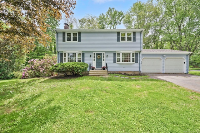 2 Broken Arrow Dr, East Granby, CT 06026 - colonial house featuring a chimney, a garage, driveway, and a front lawn