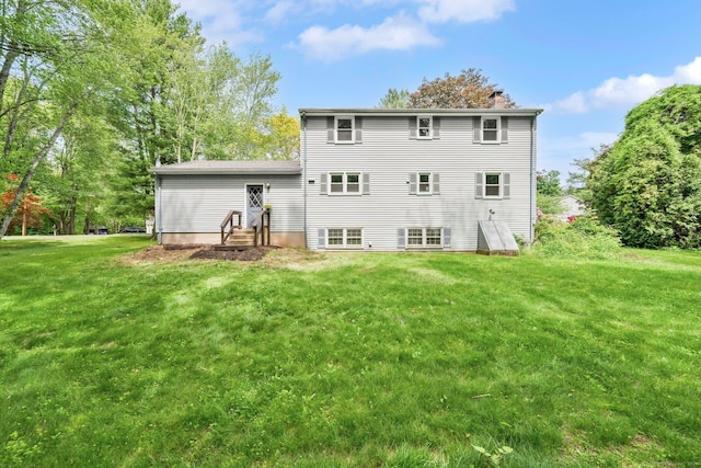 2 Broken Arrow Dr, East Granby, CT 06026 - rear view of house with a chimney and a yard