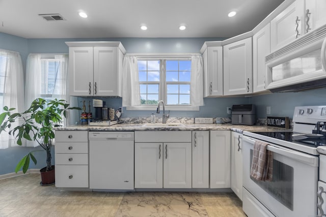 75 Redwood Dr Unit 1302, East Haven, CT 06513 - kitchen featuring white appliances, a sink, recessed lighting, white cabinetry, and light stone counters