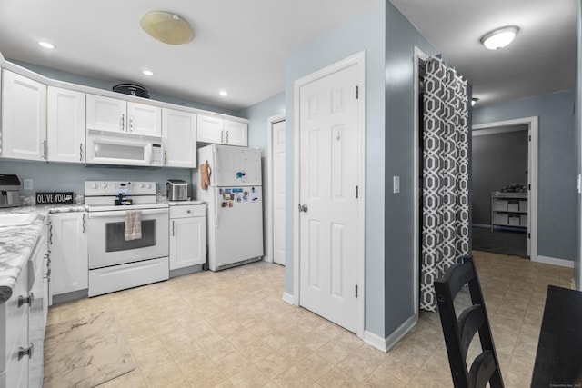 75 Redwood Dr Unit 1302, East Haven, CT 06513 - kitchen with white appliances, white cabinets, baseboards, and recessed lighting