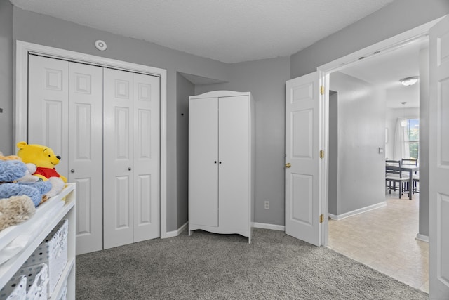 75 Redwood Dr Unit 1302, East Haven, CT 06513 - bedroom with baseboards, a textured ceiling, and carpet flooring