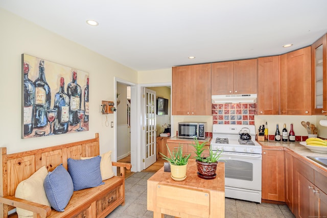 113 Toddy Hill Rd, Newtown, CT 06482 - kitchen featuring gas range gas stove, stainless steel microwave, under cabinet range hood, glass insert cabinets, and recessed lighting