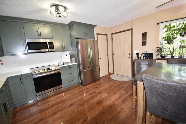 143 Pine Hill Rd Unit 8B, Thomaston, CT 06787 - kitchen with stainless steel appliances, dark wood-style floors, light countertops, and a textured ceiling