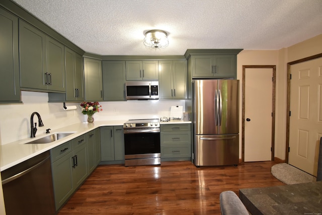 143 Pine Hill Rd Unit 8B, Thomaston, CT 06787 - kitchen with stainless steel appliances, a sink, green cabinets, and a textured ceiling