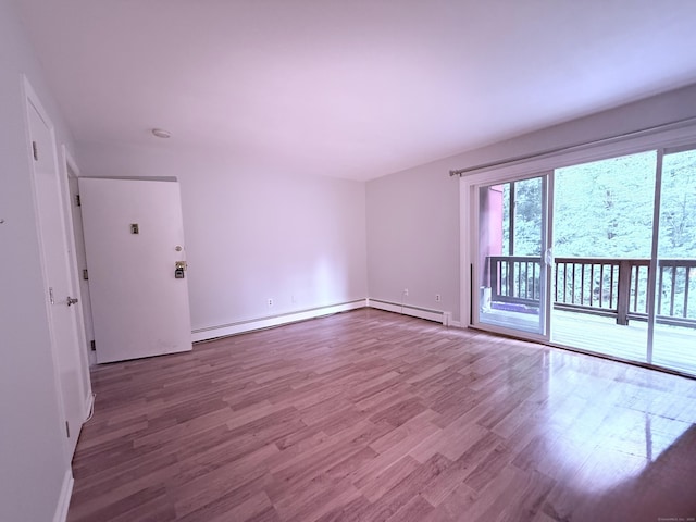 1105 Waterbury Rd Apt 1B, Cheshire, CT 06410 - empty room with wood finished floors and a baseboard radiator