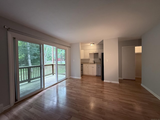 1105 Waterbury Rd Apt 1B, Cheshire, CT 06410 - unfurnished living room with a sink and wood finished floors