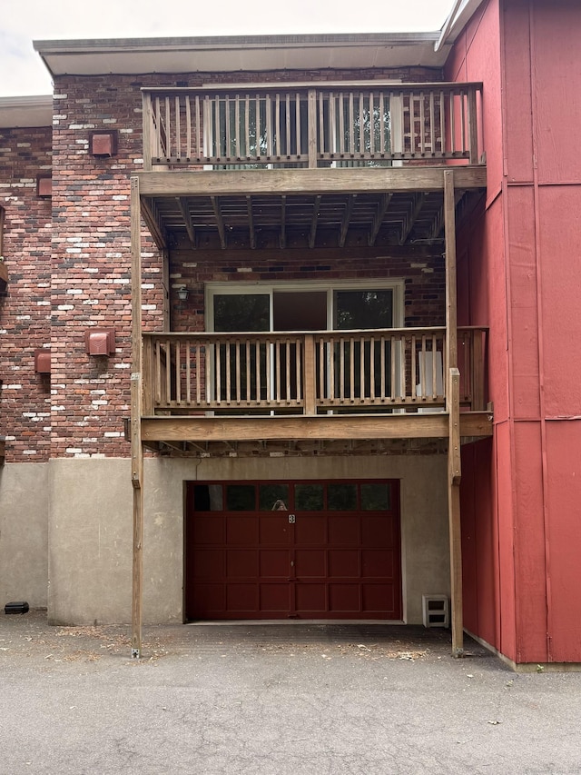1105 Waterbury Rd Apt 1B, Cheshire, CT 06410 - back of house featuring a balcony and an attached garage