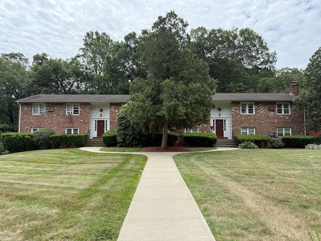 1105 Waterbury Rd Apt 1B, Cheshire, CT 06410 - split foyer home with brick siding, a chimney, and a front lawn