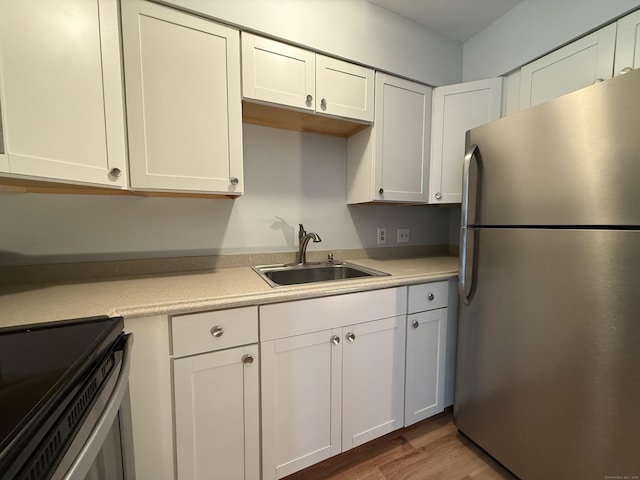 1105 Waterbury Rd Apt 1B, Cheshire, CT 06410 - kitchen with stainless steel appliances, light countertops, white cabinetry, and wood finished floors