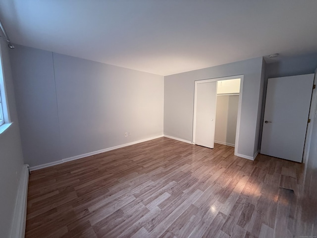 1105 Waterbury Rd Apt 1B, Cheshire, CT 06410 - unfurnished bedroom featuring wood finished floors and a baseboard heating unit