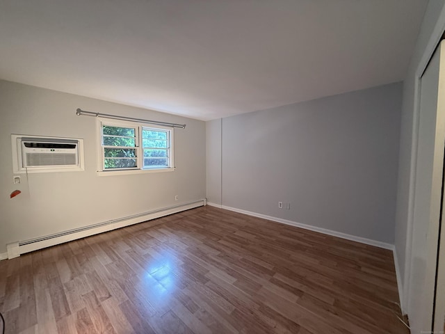 1105 Waterbury Rd Apt 1B, Cheshire, CT 06410 - spare room featuring a baseboard radiator, dark wood-style floors, and a wall unit AC