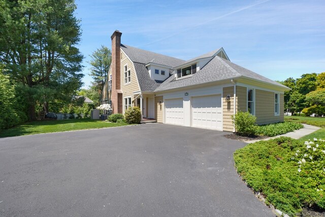 7 Sherwood Farms Ln, Westport, CT 06880 - view of front of property with an attached garage, driveway, roof with shingles, and a chimney