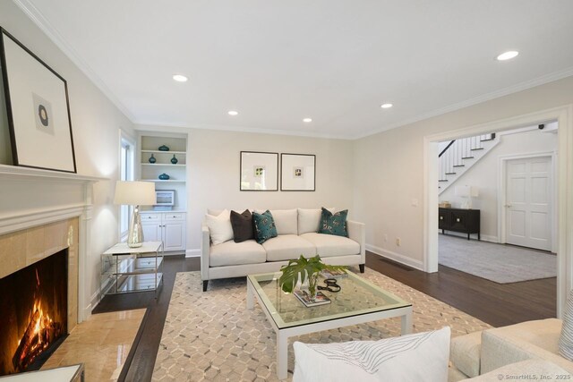 7 Sherwood Farms Ln, Westport, CT 06880 - living area featuring wood finished floors, stairway, a fireplace, built in shelves, and recessed lighting