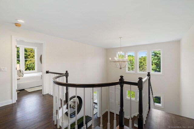 7 Sherwood Farms Ln, Westport, CT 06880 - corridor featuring an upstairs landing, a chandelier, dark wood-type flooring, and baseboards