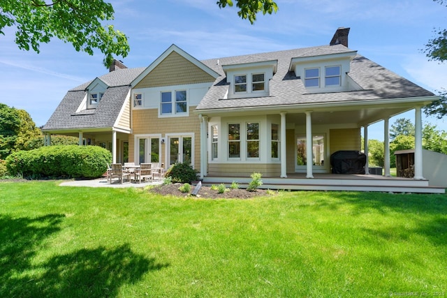 7 Sherwood Farms Ln, Westport, CT 06880 - back of house with a chimney, roof with shingles, a yard, and a patio