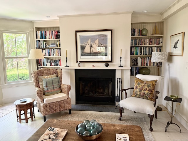 37 Orchard St, Stonington, CT 06378 - living area featuring baseboards, a fireplace, built in shelves, and crown molding