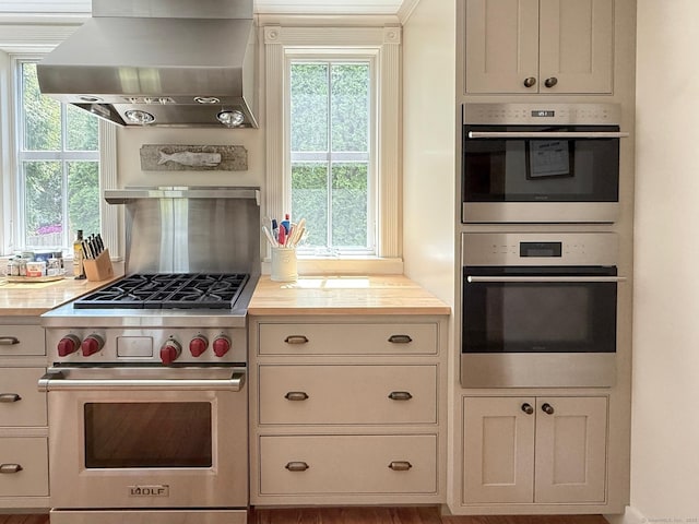 37 Orchard St, Stonington, CT 06378 - kitchen with appliances with stainless steel finishes, island exhaust hood, and wooden counters