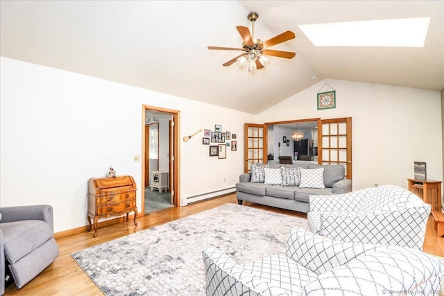 8 Prospect Ct, Brookfield, CT 06804 - living room with ceiling fan, a baseboard heating unit, vaulted ceiling, light wood-style floors, and baseboards