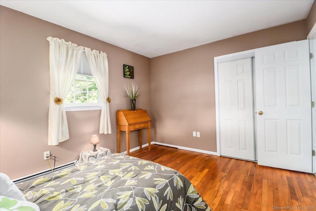 8 Prospect Ct, Brookfield, CT 06804 - bedroom with a baseboard radiator, wood finished floors, baseboards, and a closet