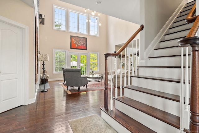100 Pembroke Ter, Glastonbury, CT 06033 - entrance foyer with wood finished floors, plenty of natural light, stairway, a towering ceiling, and baseboards