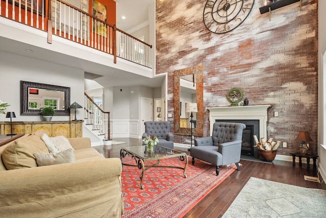 100 Pembroke Ter, Glastonbury, CT 06033 - living room featuring a high ceiling, wood-type flooring, stairs, and a glass covered fireplace