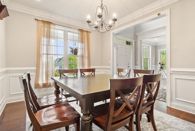 100 Pembroke Ter, Glastonbury, CT 06033 - dining space featuring a chandelier, a decorative wall, a wainscoted wall, ornamental molding, and hardwood / wood-style floors