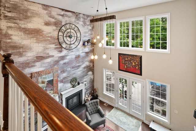 100 Pembroke Ter, Glastonbury, CT 06033 - living room featuring wood finished floors, a premium fireplace, french doors, baseboards, and a towering ceiling