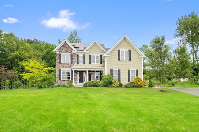 100 Pembroke Ter, Glastonbury, CT 06033 - view of front of house with a front lawn, stone siding, and solar panels
