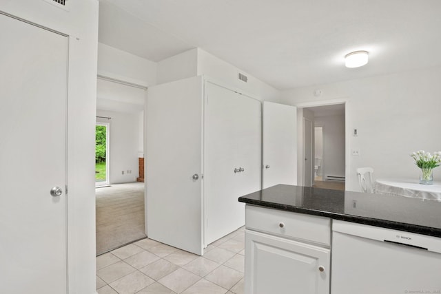 738 Heritage Vlg Unit B, Southbury, CT 06488 - kitchen featuring light tile patterned floors, white cabinets, dark countertops, light colored carpet, and white dishwasher