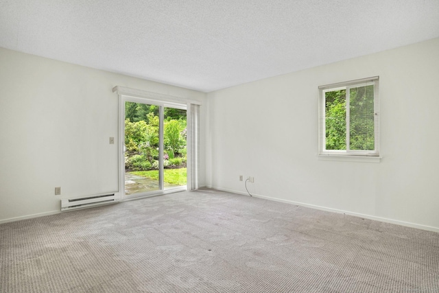 738 Heritage Vlg Unit B, Southbury, CT 06488 - empty room featuring a baseboard heating unit, carpet flooring, baseboards, and a textured ceiling