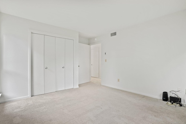 738 Heritage Vlg Unit B, Southbury, CT 06488 - unfurnished bedroom featuring light carpet, a closet, and baseboards