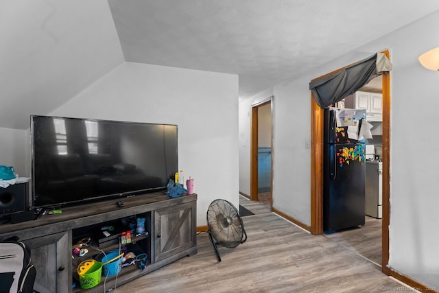 22 School St, New Britain, CT 06051 - living area featuring wood finished floors, baseboards, and vaulted ceiling