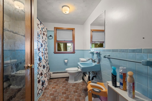 22 School St, New Britain, CT 06051 - full bath featuring a baseboard heating unit, a stall shower, tile walls, toilet, and a wainscoted wall