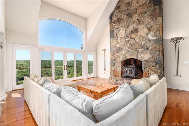 12 Fox Run, Sherman, CT 06784 - living room with high vaulted ceiling, wood-type flooring, a wood stove, baseboards, and french doors