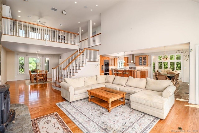 12 Fox Run, Sherman, CT 06784 - living room featuring a towering ceiling, plenty of natural light, light wood finished floors, stairway, and recessed lighting