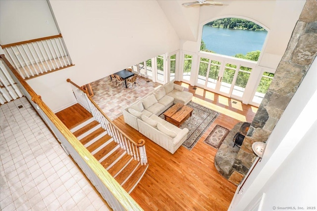 12 Fox Run, Sherman, CT 06784 - living area featuring wood finished floors, a high ceiling, a water view, ceiling fan, and stairs